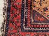 an image of a red and blue rug on a white floor