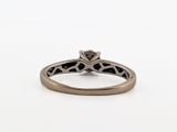 a close up of a ring with a diamond on it
