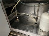 an image of a refrigerator with a water tank and a hose