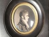 portrait of a young man in a black coat in a black frame