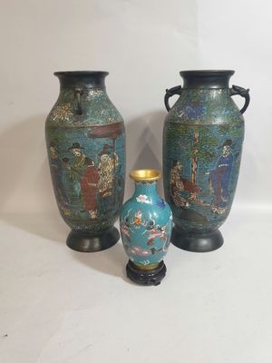 three vases sitting next to each other on a table