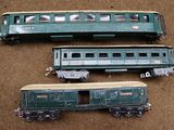 three toy trains sitting on a table next to each other