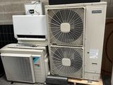 several air conditioners are stacked on top of each other in a room