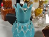 a blue pineapple shaped vase sitting on a counter