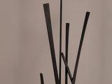 a sculpture made out of black sticks on a table