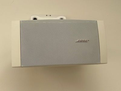 a white box with a speaker attached to it