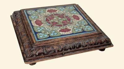 a small wooden box with a floral design on it