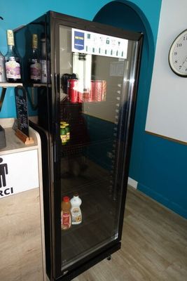 an image of a refrigerator in a room with blue walls