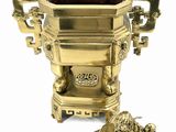 a gold urn with a lion on top of it