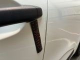 a close up of a car door handle with a sticker on it
