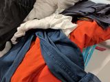 a pile of clothes sitting on top of a white table