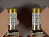 two bottles of whiskey sitting next to each other on a table