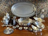 a table with a lot of silver items on it