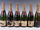 six bottles of champagne are lined up in a row