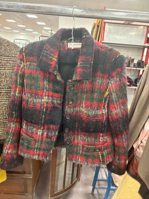 a colorful jacket hanging on a rack in a clothing store