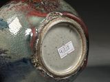 a close up of a vase with a tag on it