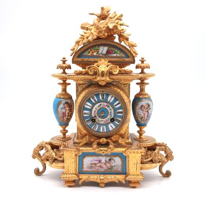 a clock that is sitting on a table with a picture on it
