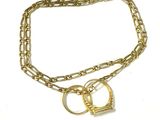 a close up of a gold chain with two rings on it