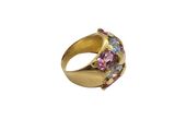 a close up of a gold ring with multi colored stones