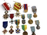 many medals and medals on display on a white surface
