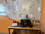 a white board on the wall next to a table