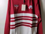 a red and white striped sweater with a tag on it