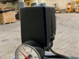 a gauge that is on the side of a blue tank