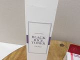 a box of black rice sitting on a table next to a box of white rice