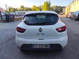 the rear end of a white car parked in a parking lot
