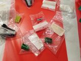many pieces of plastic on a table with scissors