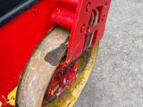 a close up of a red and black vehicle with yellow wheels