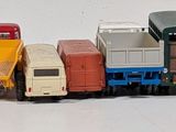 a lot of toy trains that are lined up on the table