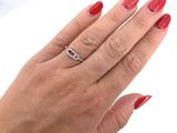 a woman ' s hand with a red manicure and a ring on it