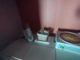 a pizza sitting on top of a stove next to a microwave