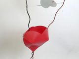 un vase rouge orné d'un cœur et d'une clé