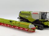 a green and red tractor and a green and red combiner
