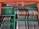 a green box with silverware in it on a table