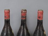 three bottles of wine sitting on top of a table next to each other
