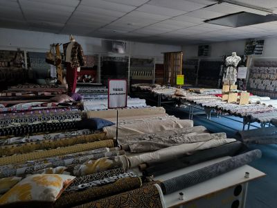 a room filled with lots of different types of fabrics