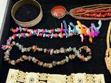 a black box filled with assorted necklaces and bracelets