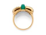 a close up of a gold ring with a green stone