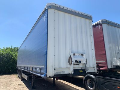 a semi truck that is parked in the dirt