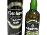 the bottle of glenlevd highland malt is next to the canister
