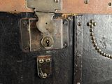 a black trunk with a chain and a lock