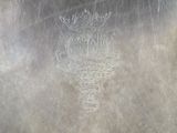 an image of a silver plate with a design on it