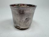 a silver cup that is sitting on a table