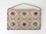 beaded purse with green and purple stones on a white background