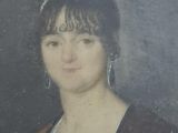 portrait of a woman in a brown jacket and a white dress