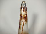 a glass vase with a tree on it on a table