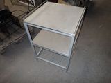 a metal table with a shelf on top of it